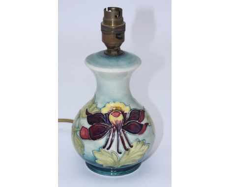 A Moorcroft pottery lamp base in the 'Columbine' pattern, of globular form and cylindrical neck, with lamp fittings and impre