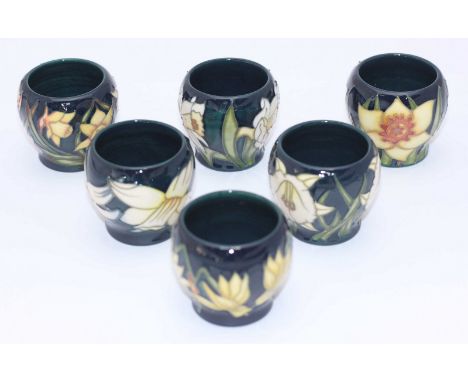 A set of six Moorcroft Egg Cups painted with flowers in the 'Narcissi' pattern, copyright 2002, 'Mushroom' symbol for product