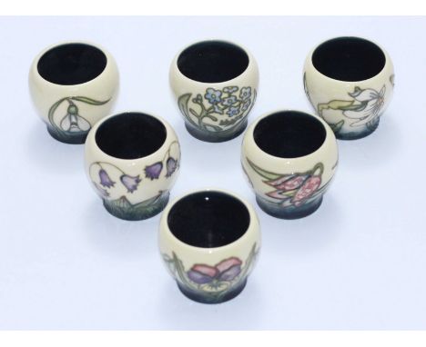A set of six Moorcroft Egg Cups painted with flowers in the 'Spring Festival' pattern, each cup double-signed by Anji Davenpo