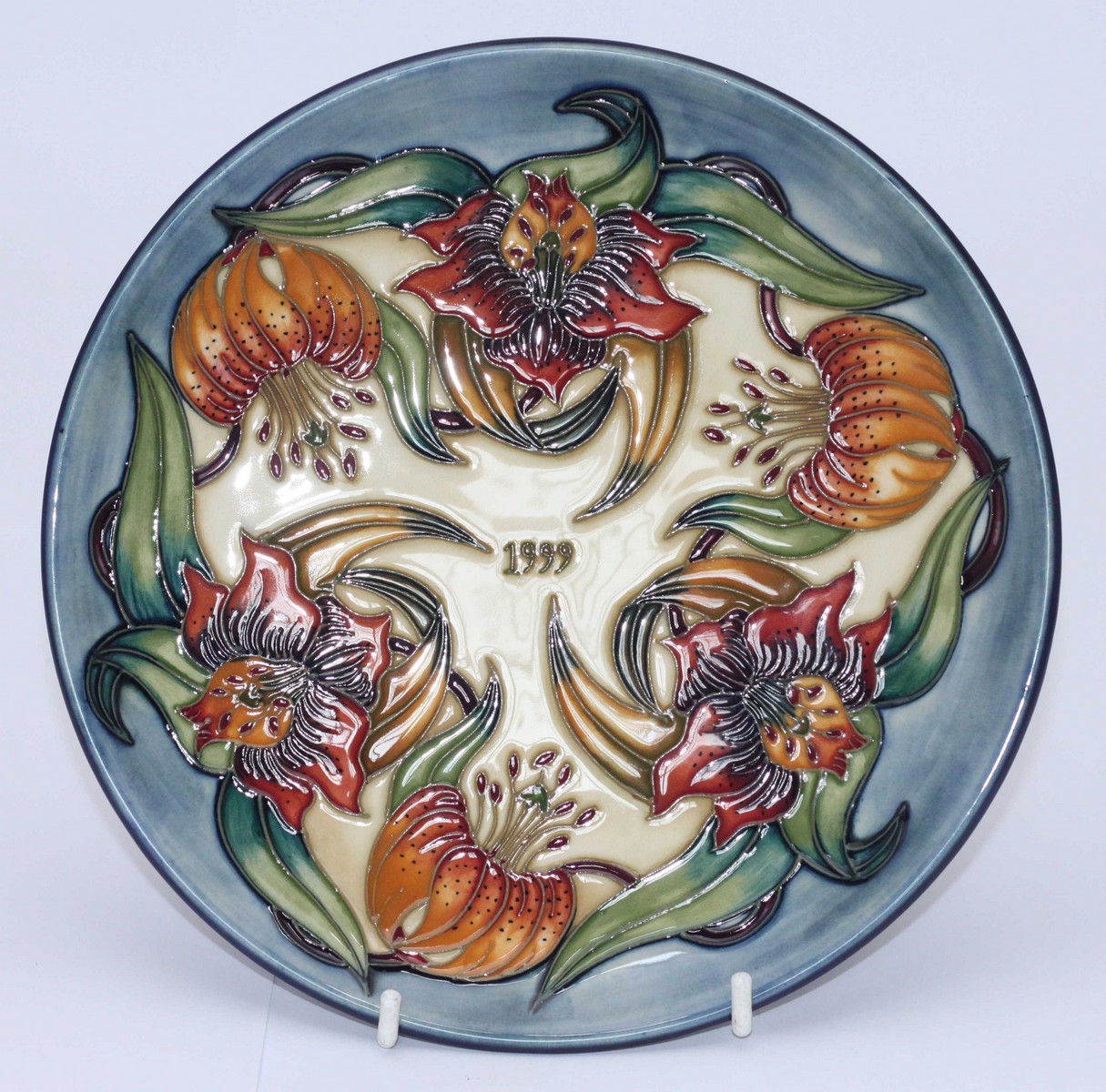 A Moorcroft pottery Year plate '1999' decorated in the 'Tiger Lily