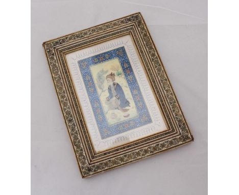 A 19th century Persian portrait study on ivory of a bearded man kneeling amidst trees, in ornate parquetry frame. 9.5 x 5cm.
