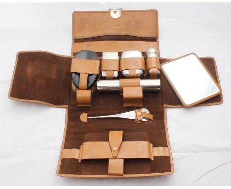 An Asprey tan-leather gentleman's travel set, with easel mirror, brush, button hook, shoehorn, shaving kit and soap-pot
