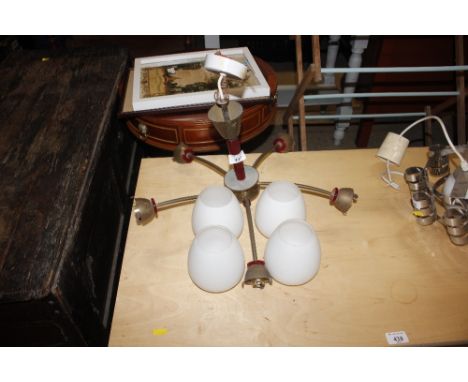 A five branch light fitting with four milk glass shades