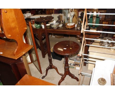 A mahogany plant stand raised on claw and ball supports AF and a tripod circular topped side table AF