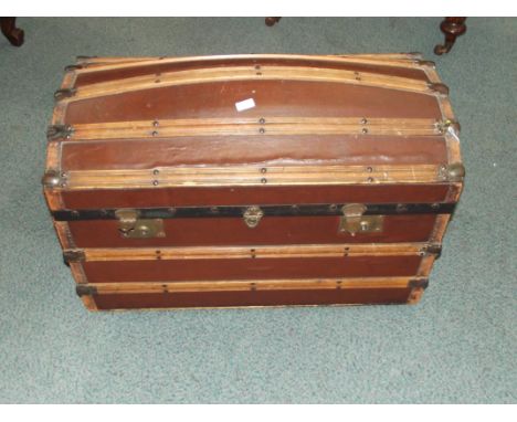 Early 20th century steamer trunk with dome lid and wood straps. 