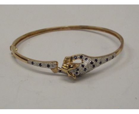 9ct gold bangle in the form of a leopard with chip diamonds and possibly sapphires weight approx 9.5grams 