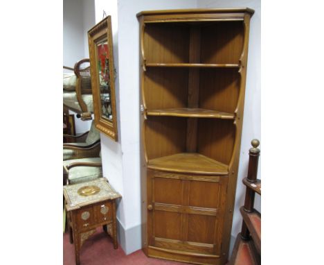 Ercol Freestanding Corner Cabinet, with open shaped shelves over panelled door, 183cm high, labelled.