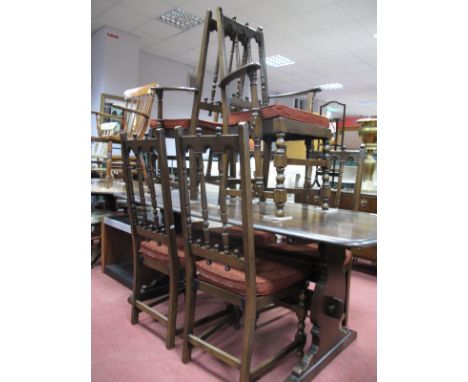 An Ercol Dining Table, together with six (four single and two carvers) rail back chairs.(7)