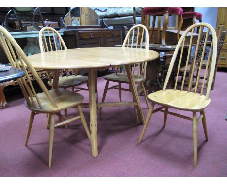 A Set of Four Ercol High Hoop Comb Back Dining Chairs, with rail spindles on splayed legs. An Ercol drop leaf table with 'X''