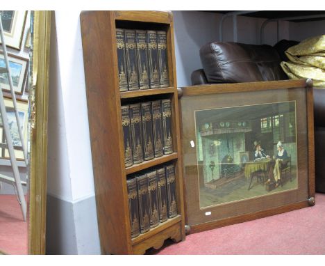 A 1930's Oak Freestanding Bookcase, housing fifteen Charles Dickens books, Louis Wolff &amp; Co. print after A. Schroder.