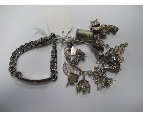 A Hallmarked Silver Curb Link Bracelet, to heart shape padlock fastener, with suspending charms, including a Cookoo Clock, a 