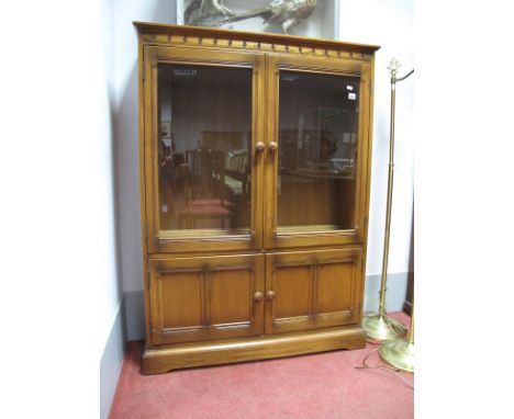 Ercol Display Cabinet, with twin glazed door over twin panelled doors, 101cm wide, labelled.