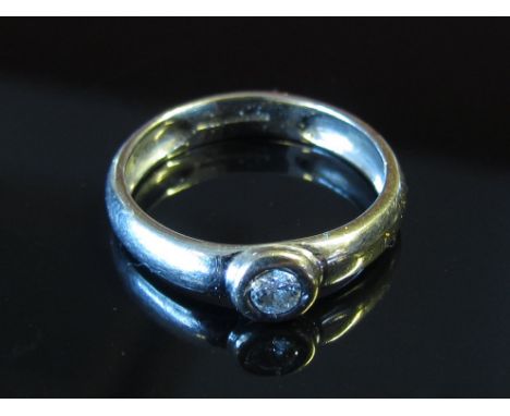 An 18ct white gold diamond solitaire in rubover setting, size K, 3.2g