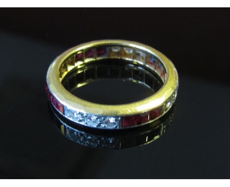 A gold diamond and ruby eternity ring. Size P/Q, 5.2g