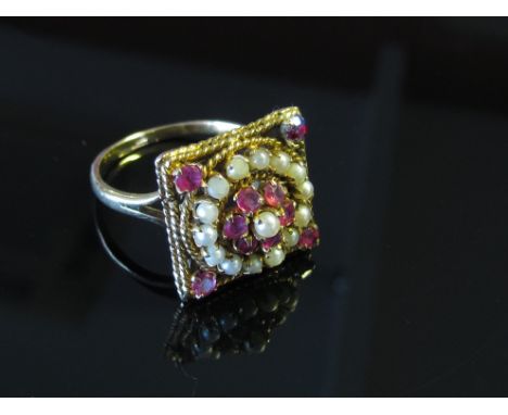 A gold ring split pearl and rubies in square mount, stamped 9ct, size S, 5g