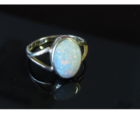 A 9ct gold ring set with an oval opal in split shoulders, size L, 2.2g