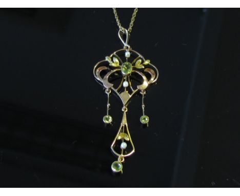 A two tone gold peridot and seed pearl pendant stamped 9ct hung on gold chain stamped 375, 4.5g