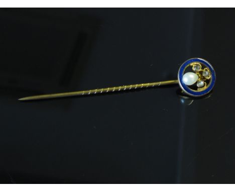 A gold stick pin set with seed pearl and chip diamonds within an enamel ring 