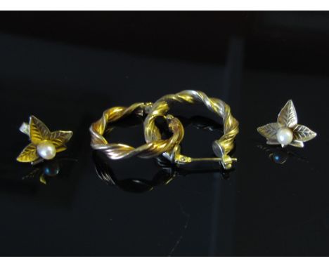 A pair of gold hoop twist earrings stamped 9kt and a pair of leaf form gold earrings with single pearl stamped 9ct, 2.4g
