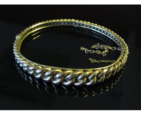 A gold "frozen" chain link bangle, unmarked, safety chain broken,  10.9g