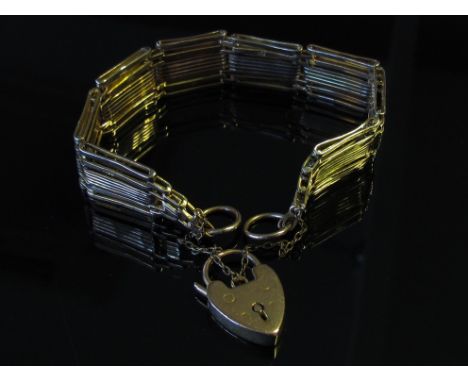 A gold gate link bracelet with padlock, stamped 9ct, 23g