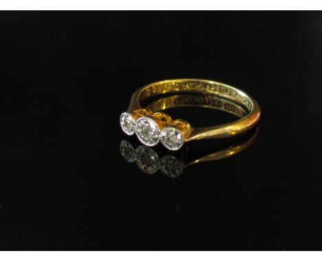 An 18ct gold three stone diamond ring, size K, 2.1g