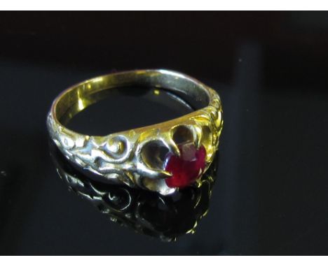 A gold ring with single claw set ruby in scrolled shoulders, unmarked, size K, 3.9g