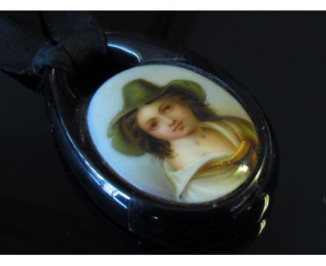 A hand painted porcelain miniature dutch portrait set in jet pendant mount (slight crack to jet)
