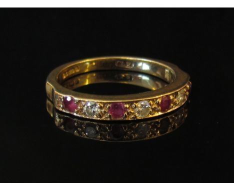 A 9ct gold diamond and ruby half hoop, size K/L, 2.1g