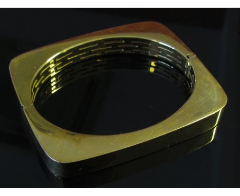 A gold bangle of rounded rectangular shape, marked VI, 50.5g