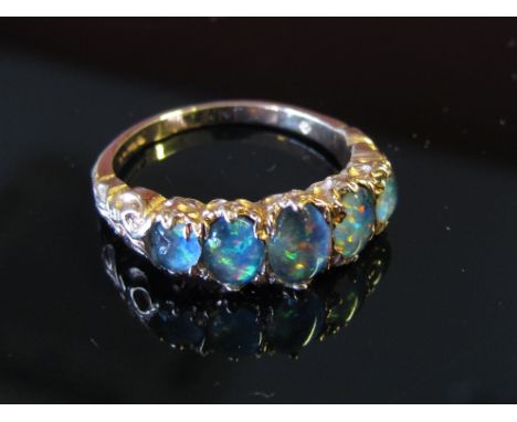 A 9ct rose gold blue opal five stone ring, size M, 2.9g