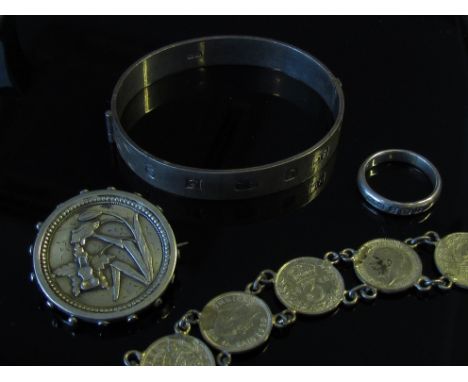 A silver stiff hinge bangle, a coin bracelet, silver band and a brooch