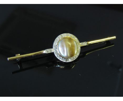 A bar brooch centrally set with brown pearl framed by diamonds, unmarked, 6.5g