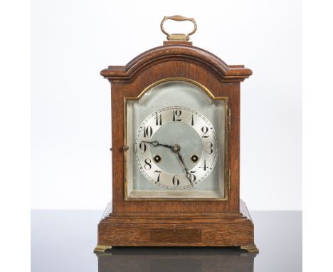 EARLY TWENTIETH CENTURY OAK MANTEL CLOCK
by Junghans, Germany, signed two train movement striking on a coiled gong, the arche