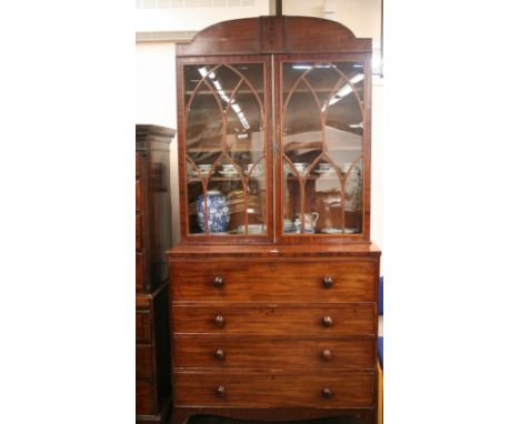 A Georgian mahogany secretaire bookcase, the upper adjustable shelves enclosed by a pair of boxwood strung glazed astragal do