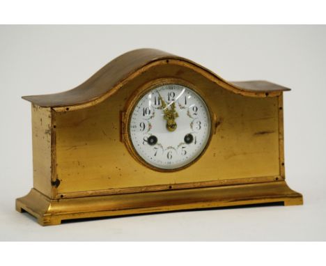 An Edwardian brass cased mantel clock, having circular white enamel dial, decorated with garlands of flowers, 8 day movement 