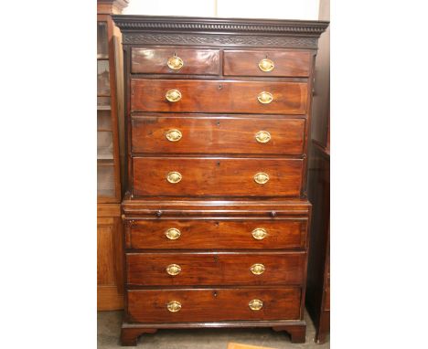 A George III mahogany chest on chest, the upper section surmounted by a stepped pediment with blind fret decoration above two