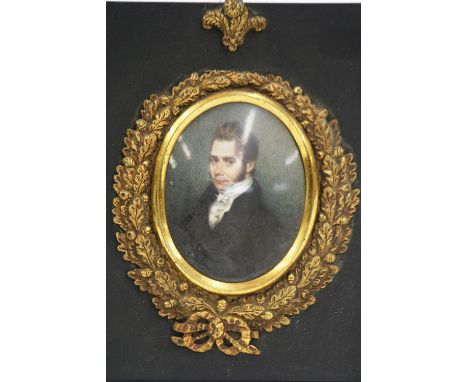 19th Century school, oval portrait miniature of a young gentleman in frock coat and stock, ebonised frame with gilded laurel 