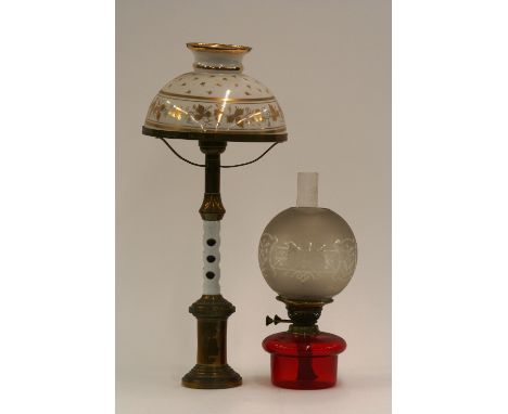 A brass and overlaid glass column table lamp, having gilt decorated and opaque glass shade; and a Victorian ruby glass oil la