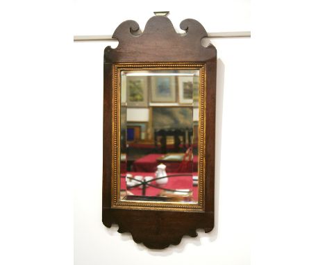 A 19th Century mahogany Chippendale style wall mirror, having bevelled plate and gilt beaded slip, 62cm x 30cm in extremes
