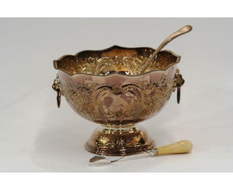 A plated punch bowl, with gadroon border and foliate embossed decoration, 27cm dia. x 19cm high; a plated punch ladle with mo