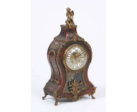 A late 19th Century French tortoise shell and cut brass inlaid mantel clock, in the manner of Boulle, surmounted by gilded ch