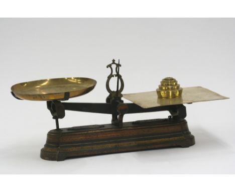 A set of French iron and brass shop scales, and graduated weights, 67cm long