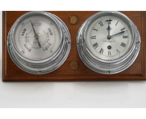 A chrome plated clock and barometer set, by Simpson Lawrence Ltd. Glasgow, set to a mahogany plinth