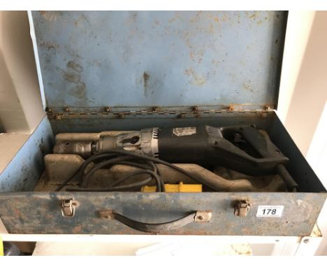 An electric jack hammer drill in metal carrying case
