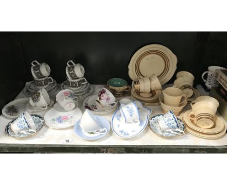 A shelf of porcelain tea ware including Royal Albert