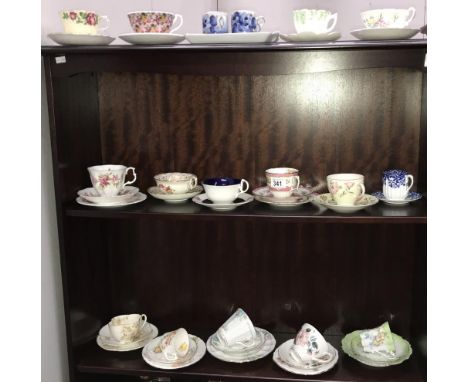 3 shelves of porcelain tea cups and saucers including trios