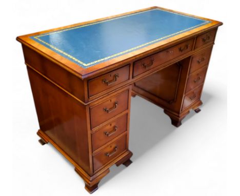 An reproduction yew wood pedestal kneehole desk, by Iain James Furniture, teal tooled leather inlaid writing surface, 77cm x 