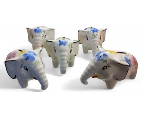 Five Arthur Wood money banks, in the form of comical elephants, painted in colours with stylised flowers, printed marks