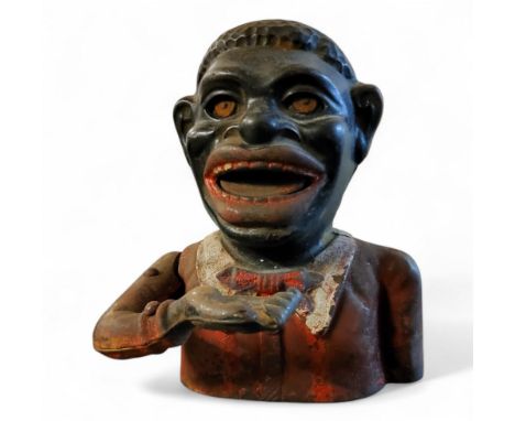 A Victorian cast iron Jolly black man money bank,  16cm high Notice from the the-saleroom.com: These items are listed on the 
